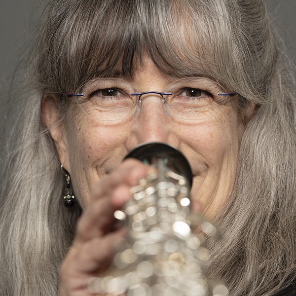 An up close portrait of Laura Reynolds and her instrument