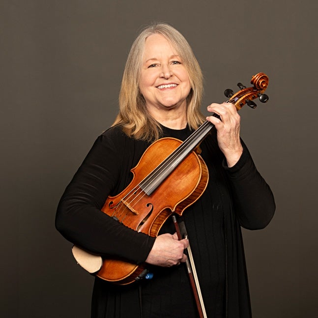 A portrait of Meg Titchener and her instrument