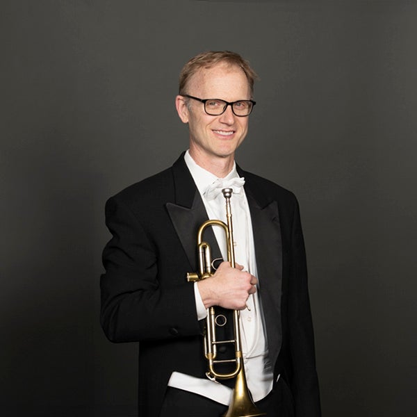 A portrait of Scott Macomber and his horn