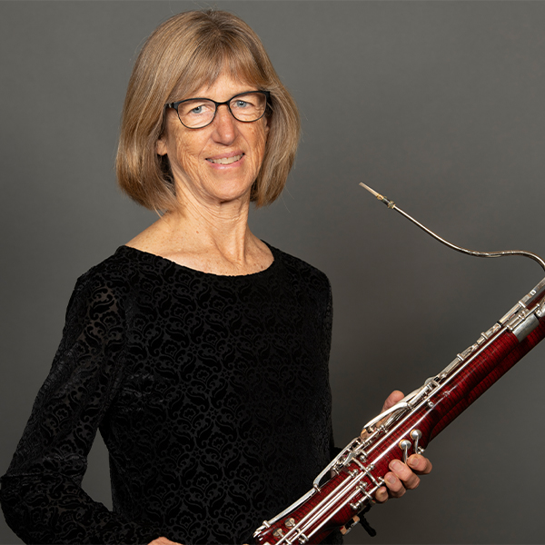 A portrait of Carla Wilson and her bassoon