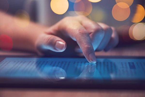 Woman reading online news on digital tablet,