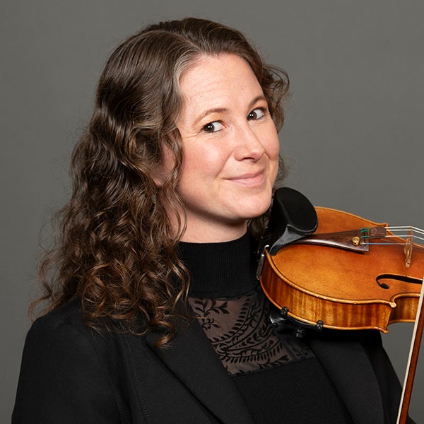 A portrait of Caitlin McSherry and her violin