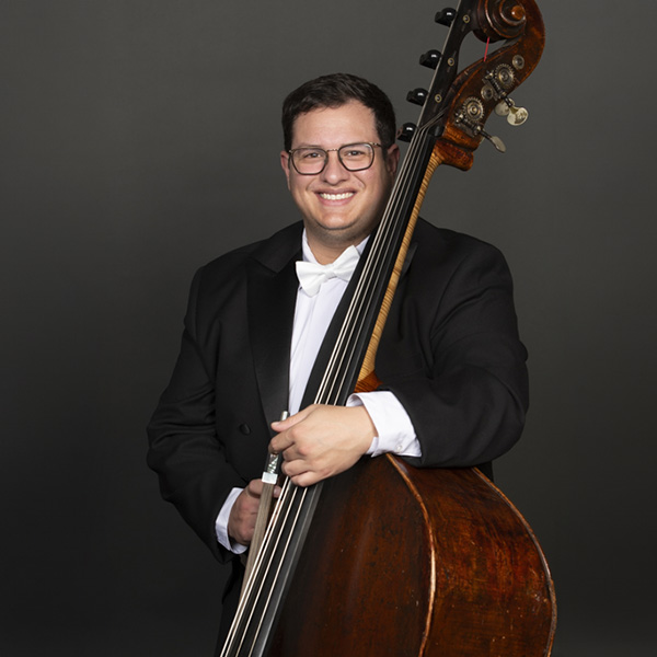 A portrait of Kody Thiessen and his contrabass