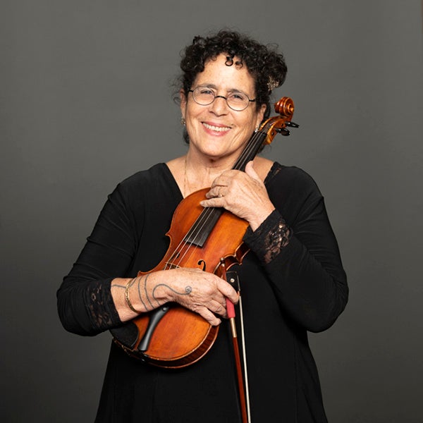 A portrait of Laurie Moore and her instrument