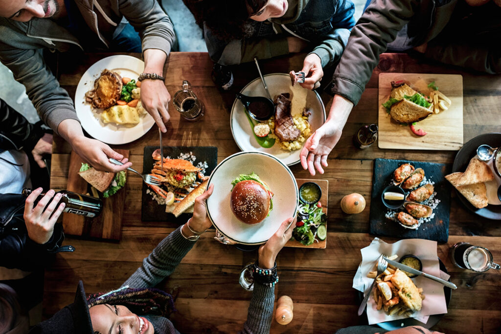 Overhead shot of group of friends enjoying a meal at a hipster restaurant