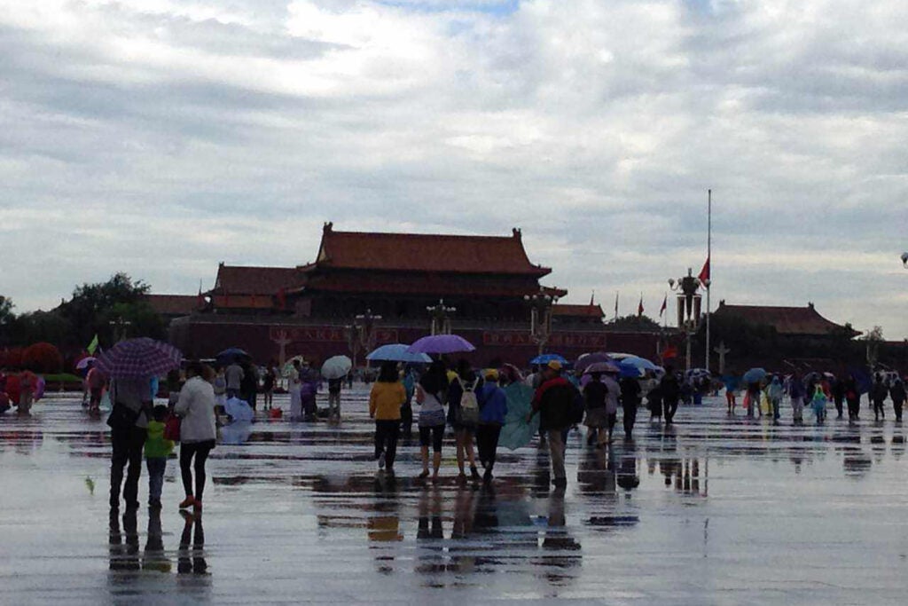 tourists walking in the rain with umbrellas