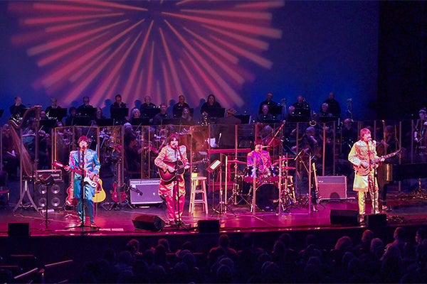 Musicians for the pops series, on stage, looking like the beatles