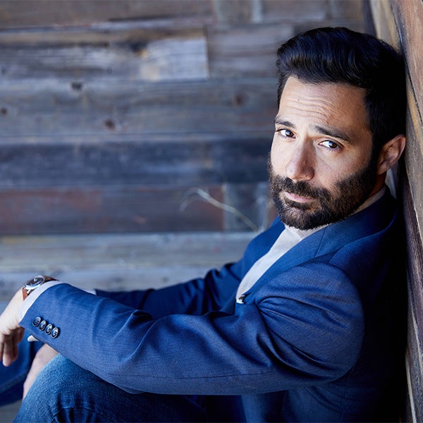 Paul Loren sitting on the floor for a professional headshot