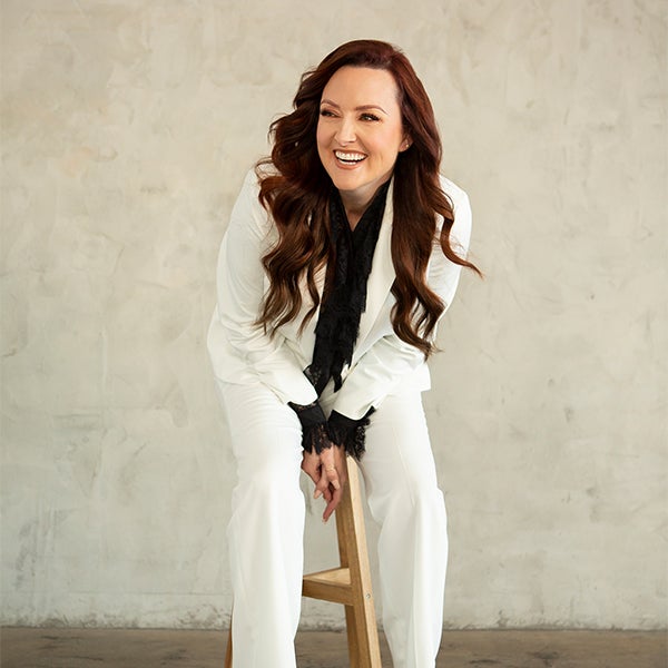 A portrait of a woman smiling and laughing