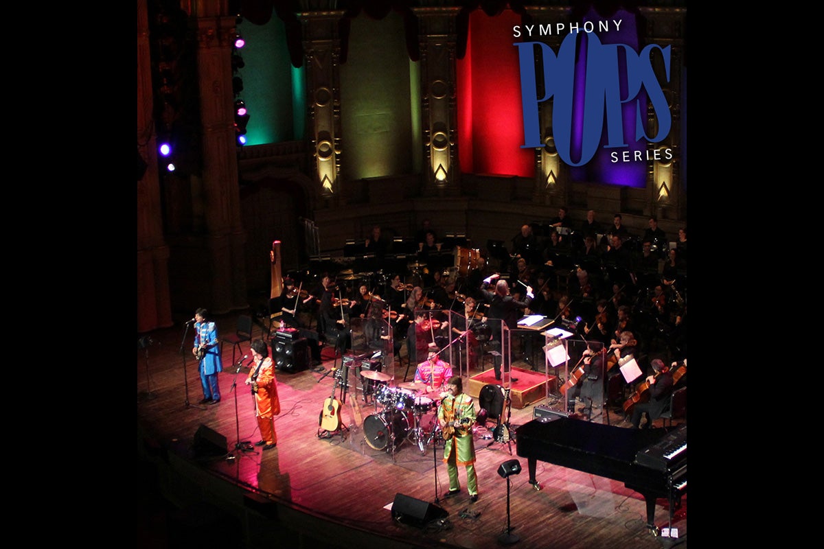 Musicians on the stage for pops series looking like the beatles